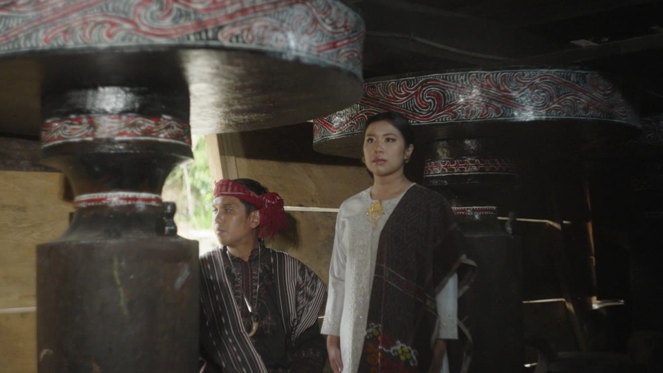 Traditional ceremony scene with a couple inside a wooden house